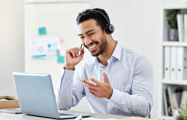 Asian man, laptop or call center worker in communication, customer service or contact us support office. Smile, happy and excited crm consultant or telemarketing receptionist on tech sales consulting.